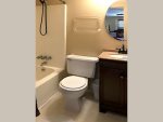 Full size bath with tub/shower combo and closet to right of vanity